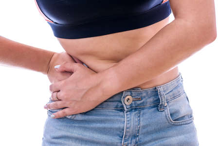 Female hands on belly, pain concept isolated on whiteの写真素材