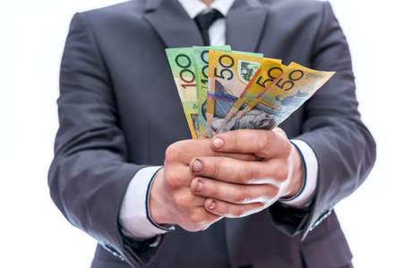 Man in suit offer australian dollar banknotesの写真素材