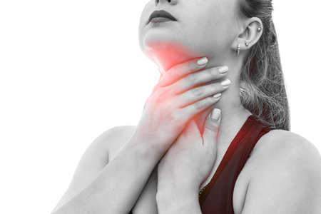 Woman touching her throat isolated on white
