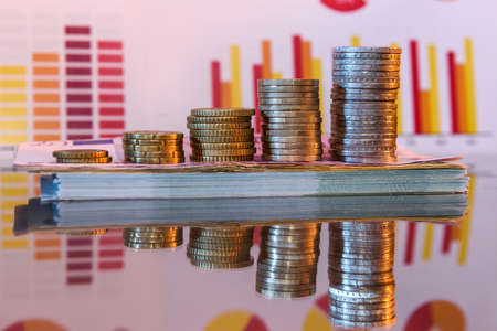 Stack of paper euro and coins with reflectionの写真素材