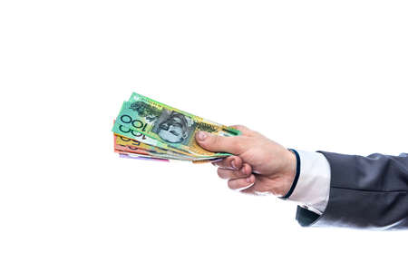 Male hand with australian dollars isolated on whiteの写真素材