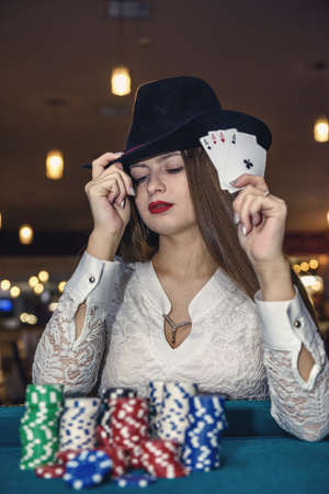 Woman in casino showing combination of aces