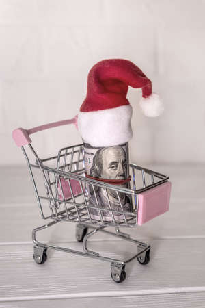 Dollar roll with santa hat in toy trolleyの写真素材