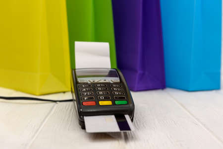 Colorful shopping bags with terminal and credit card