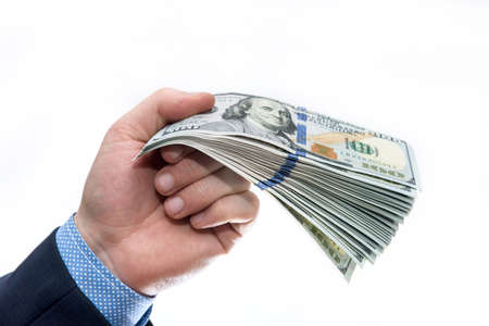 Pile of dollar banknotes on male's palm isolated on white
