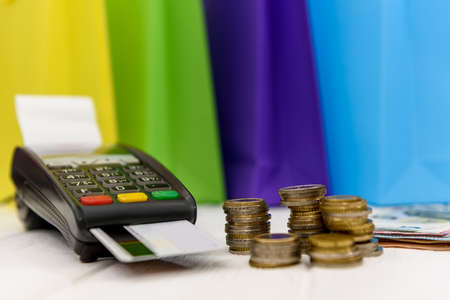 Shopping concept with terminal, card and euro coins