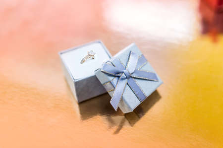 Golden engagement ring in silver gift boxの写真素材