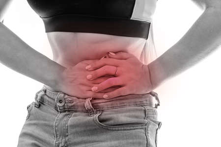 Female hands on belly, pain concept isolated on whiteの写真素材