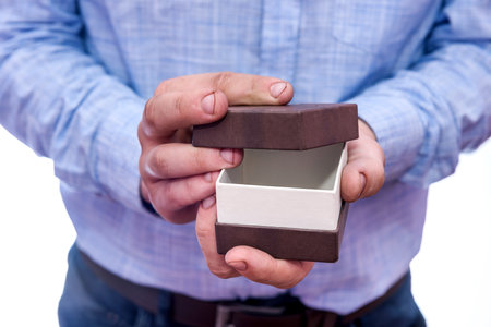 Man opening gift box, making surprise close upの写真素材