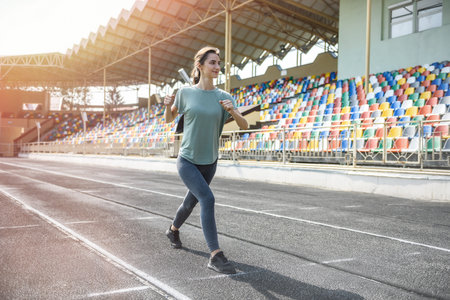 Young woman making exercises in big city on urban landscape