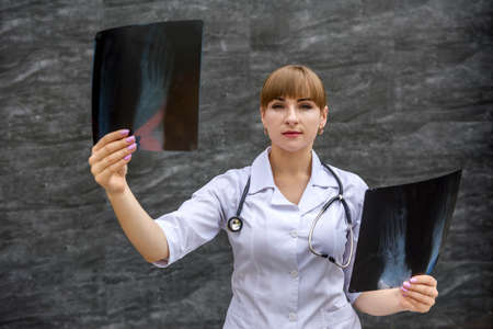 Nurse student examines X-ray of foot. Medical concept.の写真素材
