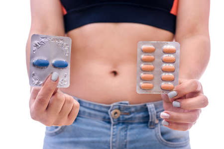 Medicine theme. Woman showing pills in blister isolated on white