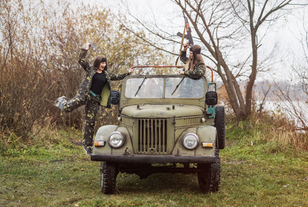 Young women soldiers with rifle and knife