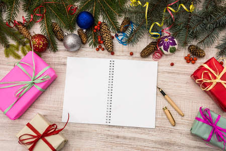 Plans for new year. Open diary on table with gift boxes and fir branchesの写真素材