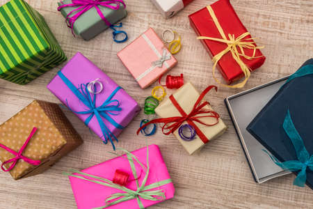 Colorful gift boxes on wooden table top view. Presents, new year and Christmas celebration