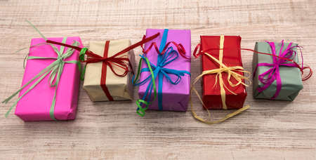 Colorful gift boxes on wooden table top view. Presents, new year and Christmas celebration