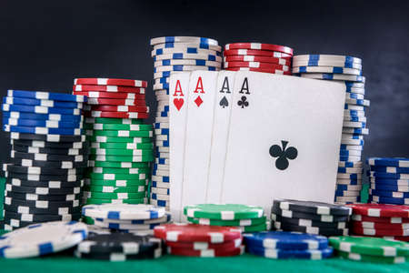 Gambling concept. Four aces combination with poker chips on green tableの写真素材