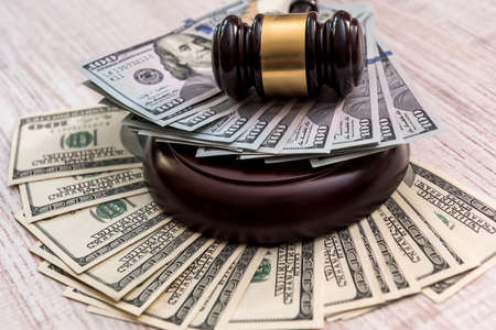 Money and judges hammer on wooden table