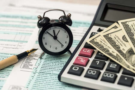 US tax form with moneyの写真素材