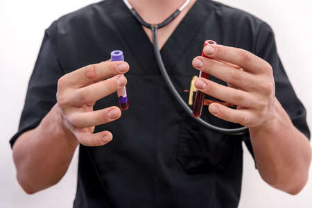 Male hand in protective gloves holding test tube with blood sampler isolated on whiteの写真素材