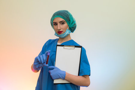 Woman researcher doing a blood test with clipboardの写真素材