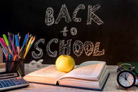 School blackboard with text 'Back to school'. September and education concept