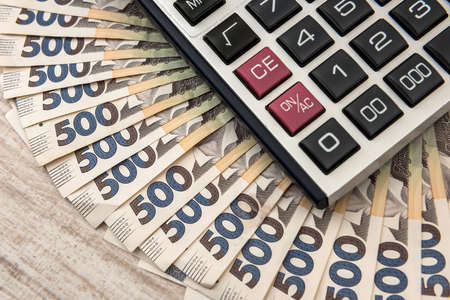 500 hryvnia bills with calculator as background. Close up. Top view