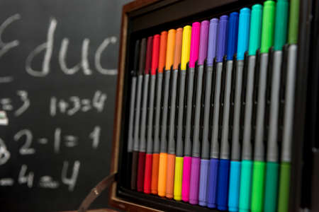 Set of colorful pencils. School supplies in wooden box. Education concept.