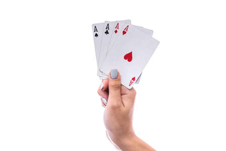 Gambling concept. Female hand holding combination of four aces isolated on whiteの写真素材