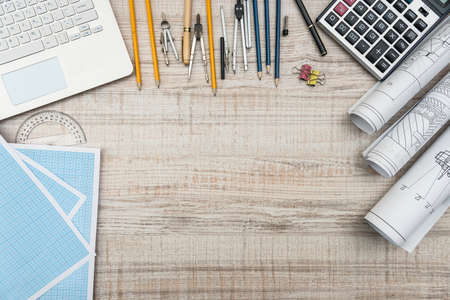 Workplace of engineer. Top view of laptop, notepad, and drawing toolsの写真素材