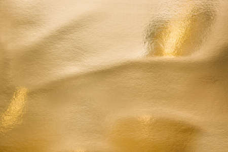 Gold texture as background. Paint leaks and ombre effects. Gold metallic foilの写真素材