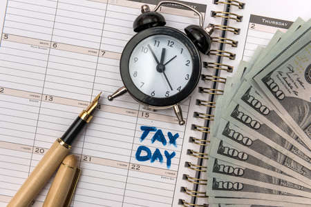 Text Tax Day on notepad. Tax concept