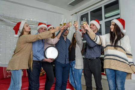 Group of people in sweaters celebrating new yearの写真素材