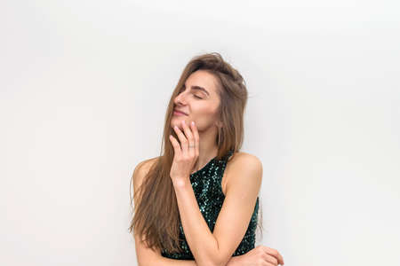 Fashion woman in elegant dress touching her hair. Sensual portrait of attractive womanの写真素材
