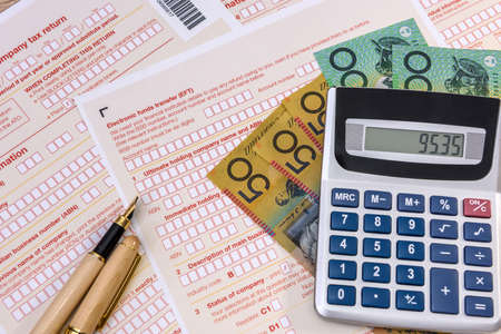 Australian tax form with pen, calculator and australian dollarsの写真素材