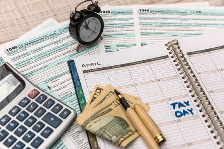 US 1040 Tax form with notepad, calculator and pen. Tax concept.の写真素材