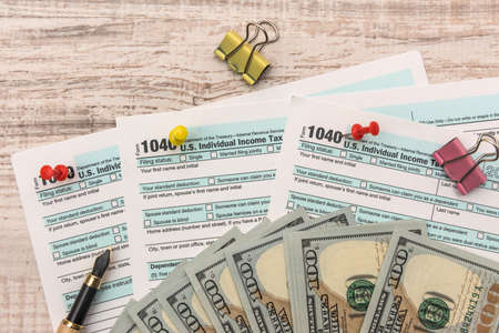 1040 Tax form with us money and pen. tax concept
