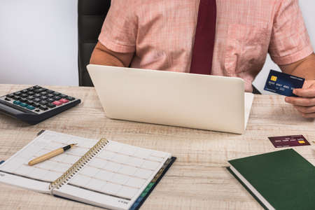 Young business man paying online with credit card.の写真素材