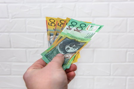 Hand holds Australian dollars isolated on white backgroundの写真素材