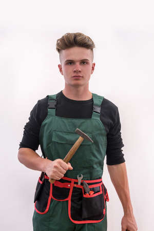 Renovation concept. Young man with tools isolated on white background