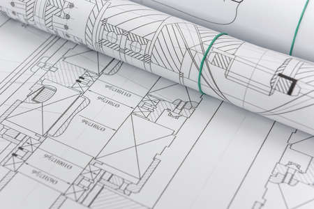 Technical drawings with blueprints in rolls close up. Engineering concept