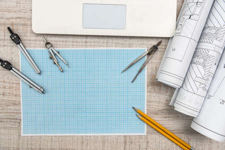 Workplace of engineer. Top view of laptop, notepad, and drawing tools