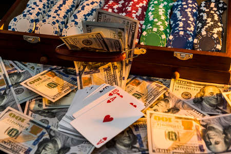 a grand casino super prize - a case full of chips, dollars and playing cards on a black backgroundの写真素材