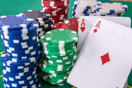 Two aces and poker chips on table close up. Gambling concept