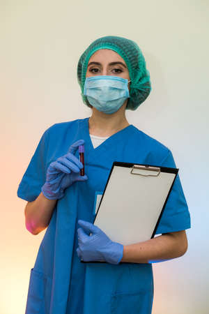 Woman researcher doing a blood test with clipboardの写真素材