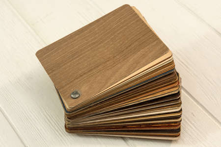 Samples of laminate planks on wooden desk for new construction or renovation building