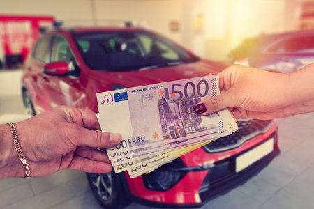 The buyer gives the seller a euro to enter into a contract to buy or lease a car.の写真素材