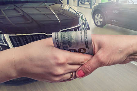 Buying a new car. The buyer and seller enter into an agreement to buy or lease a car.