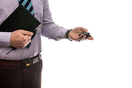 businessman gives car keys to car isolated on white backgroundの写真素材