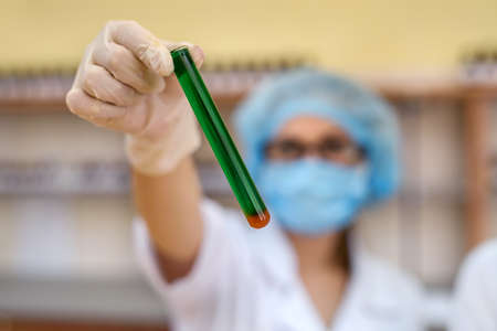 Science. Woman chemist in laboratory holding test tube close upの写真素材